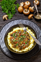potato mash topped with mushroom gravy in bowl