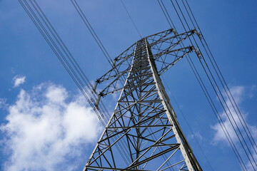 power lines overhead. Electricity pylons and blue sky. 