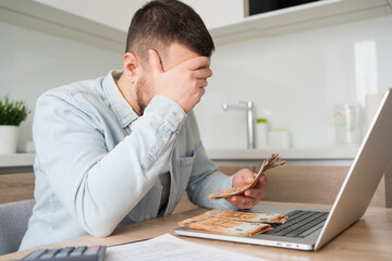 Fototapeta premium business, finances problems, accounting and people concept , man with money and calculator filling papers at home. savings, economy and home 