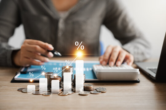 Interest rate and dividend concept, Businesswoman calculates investment returns with percentage symbol and up arrow, return on stocks and mutual funds, long term investment for retirement.
