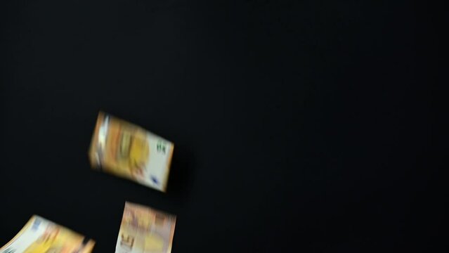 Slow flow towards euro banknotes currency movement background, money flying endless flow on black background.