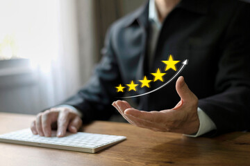 Customer satisfaction review concept. Businessman hand giving five star for quality rating on...