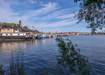 Bay view over a wharf on the island Långholmen at the pier Södermälarstrand, cumulus clouds, a...