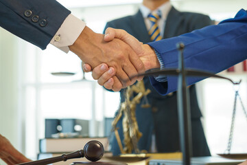 A team of lawyers shares knowledge and discusses difficult cases. from one's conduct Lawyers reviewing court documents. Defendant, defense lawyer and relatives standing in the courtroom. African