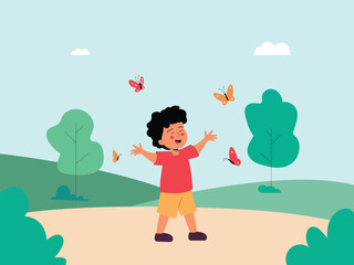 A boy is playing with butterflies in a field