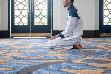 Muslim men praying in Tashahhud posture