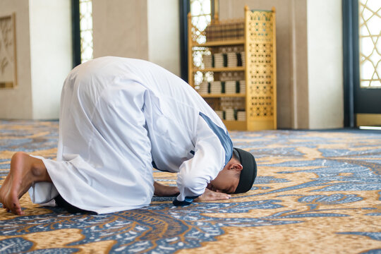 Muslim men praying in sujud or prostration posture