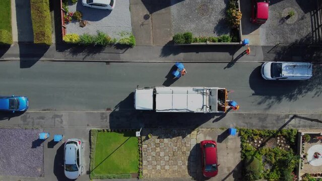 Drone. Waste collection truck in urban street collecting trash. Filmed. Yorkshire.UK. 