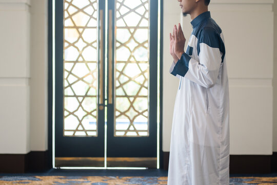 Asian muslim man solat and takbir take his hands up. Islam praying