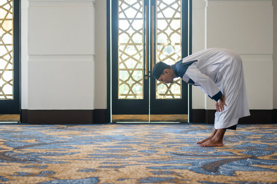 Muslim men praying in Ruku posture
