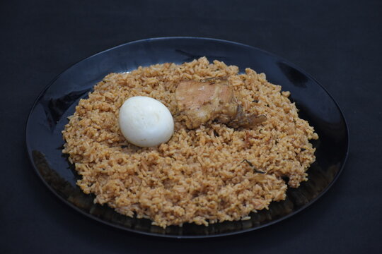 tasty spicy chicken briyani with raitha gravy curd onion indian lunch recipe plate black background