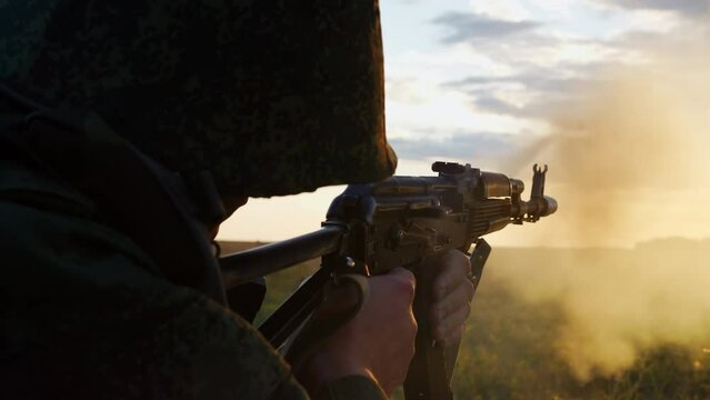 Soldier shoots from machine weapon and attack enemies, fight with military conflict. Armed forces invade special operation, firearm combat in war service