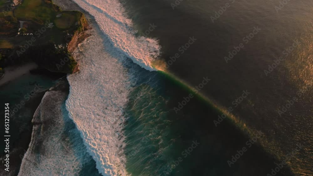 Wall mural aerial drone view coastline with surfing big waves. perfect ocean waves with warm sunset light in ba - Wall murals