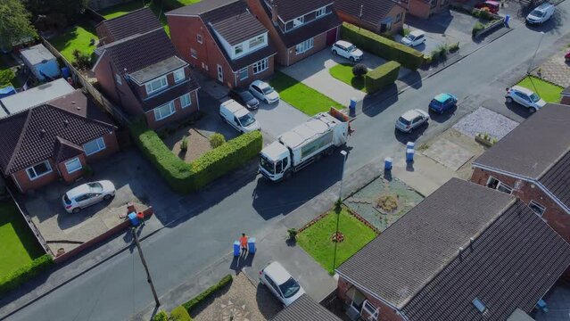 Drone. Waste collection truck in urban street collecting trash. Filmed. Yorkshire.UK. 