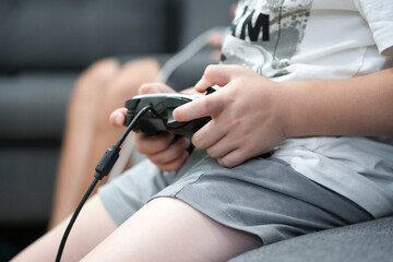 Child Holding a Video Game Controller: Addressing Children's Dependency on Technology and Video Games
