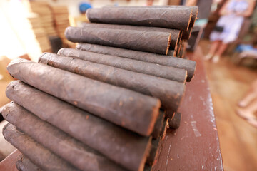 Closeup on stacked hand-rolled cigars.