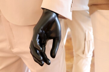A mannequin stands on a display window in a supermarket.
