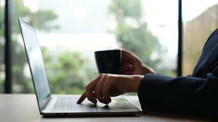 Woman working at home office hand on keyboard close up
