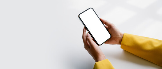 Close-up of a young woman holding a smartphone, typing a message, talking with friends. on social networks Concept of using mobile application, online shopping, opening website, ordering food, busines