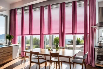 Fototapeten Gray roman shades and a pink curtain over large, glass windows in a modern kitchen and dining area with a wooden table and white chairs © Tanveer