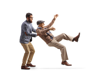Younger man catching an elderly man falling