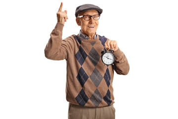 Elderly man holding an alarm clock and pointing up