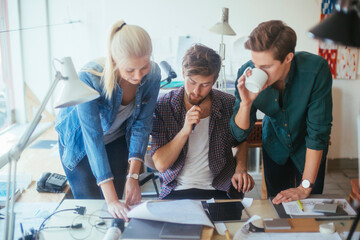Young and diverse group of architects working on a project together in a startup company office