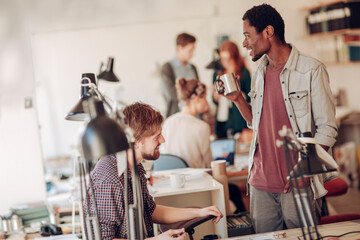 Two young and diverse architects working on a architectural drawing in a modern business office