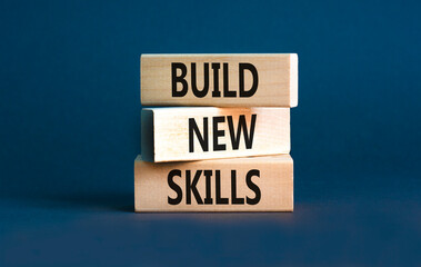 Build new skills symbol. Concept word Build new skills on beautiful wooden block. Beautiful grey table grey background. Business, education build new skills concept. Copy space.