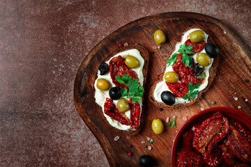 sandwich with cream cheese, dried tomatoes, olives, breakfast, top view,