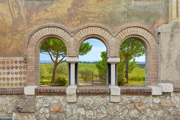 Beautifully painted house facade with Romanesque windows. Depending on the requirements, a beautiful background, for example a Tuscany picture, can be mounted.