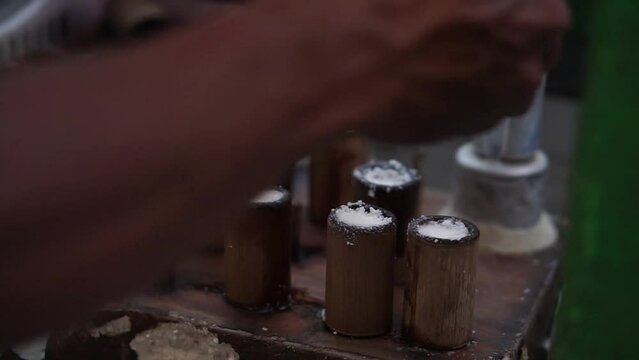 The process of making putu cake which is put into a mold made of bamboo and then steamed with steam, a traditional Indonesian snack.