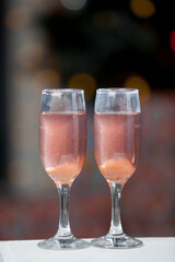 Two glasses of pink champagne for the couple.