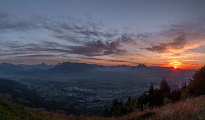 Sunset view from Gaisberg hill over Salzburg city in summer hot evening