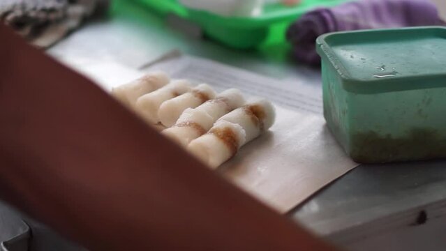 The process of making putu cake which is put into a mold made of bamboo and then steamed with steam, a traditional Indonesian snack.