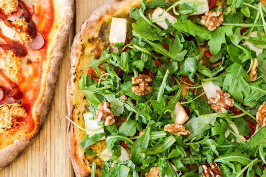 Appetizing pizza with walnut and lettuce