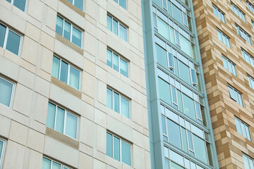 skyscraper in a bustling city, symbolizing innovation and growth in the modern commercial real estate industry. Dynamic, glassy exterior reflects urban vitality