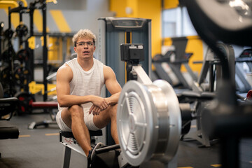 Fototapeta na wymiar portrait Muscular young man training at gym, confident bodybuilder working out with weights in sport club, bodybuilding concept , with exercise equipment and dumbbells.