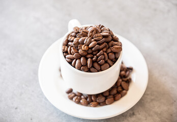 cup of coffee that full of coffee beans on grey living room table