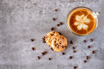 Top view for cup of coffee with cookies and coffee beans on grey background