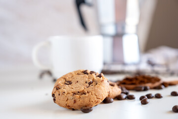 Two pieces of cookies with coffee set in the background