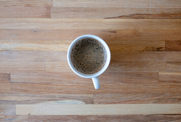 Cup of coffee on wooden background