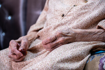 Old woman hands wrinkled feeling lonely without her husband