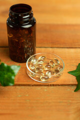 Gold pills in glass container, d3k2 supplement, vitamins and minerals