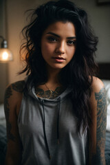 Fototapeta premium Portrait of a serious woman on a bedroom wearing casual clothes dark hair