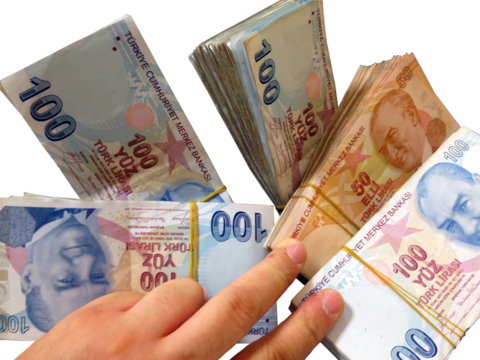 human hand holding stacks of hundred and fifty Turkish lira bills