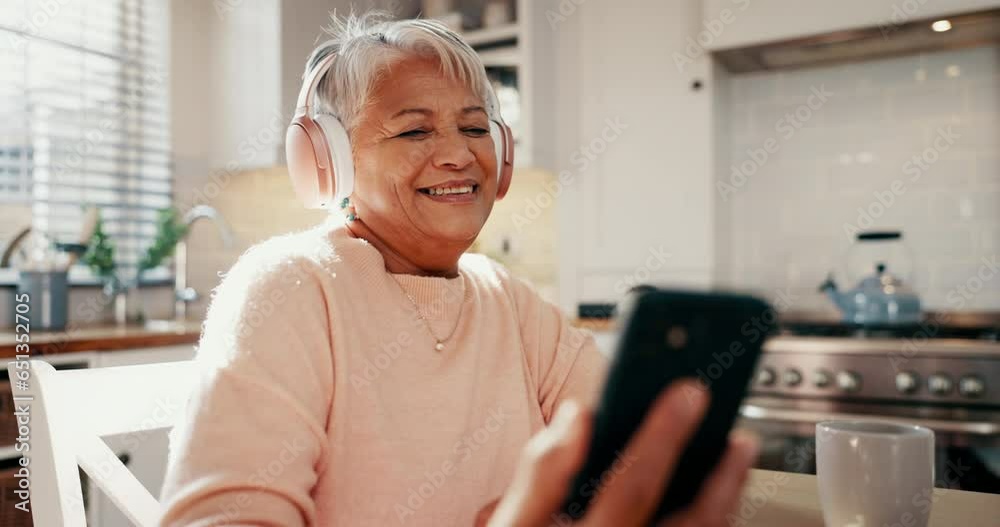 Poster Headphones, cellphone and senior woman in the kitchen listening to music, album or playlist. Happy, dance and elderly female person streaming song and reading blog on social media or internet at home