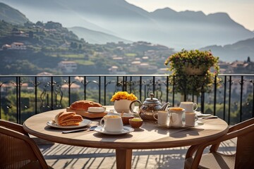 Fototapeta premium Breakfast with coffee and fresh pastries on the terrace overlooking the mountains