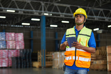 factory worker working on tablet in the warehouse storage