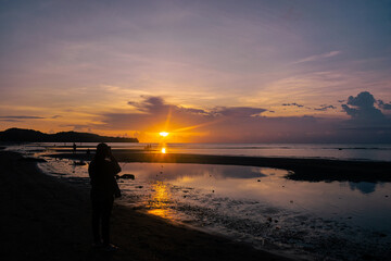 Fototapeta premium Silhouette of a person at sunset on the beach. Odiongan, Romblon, Philippines.